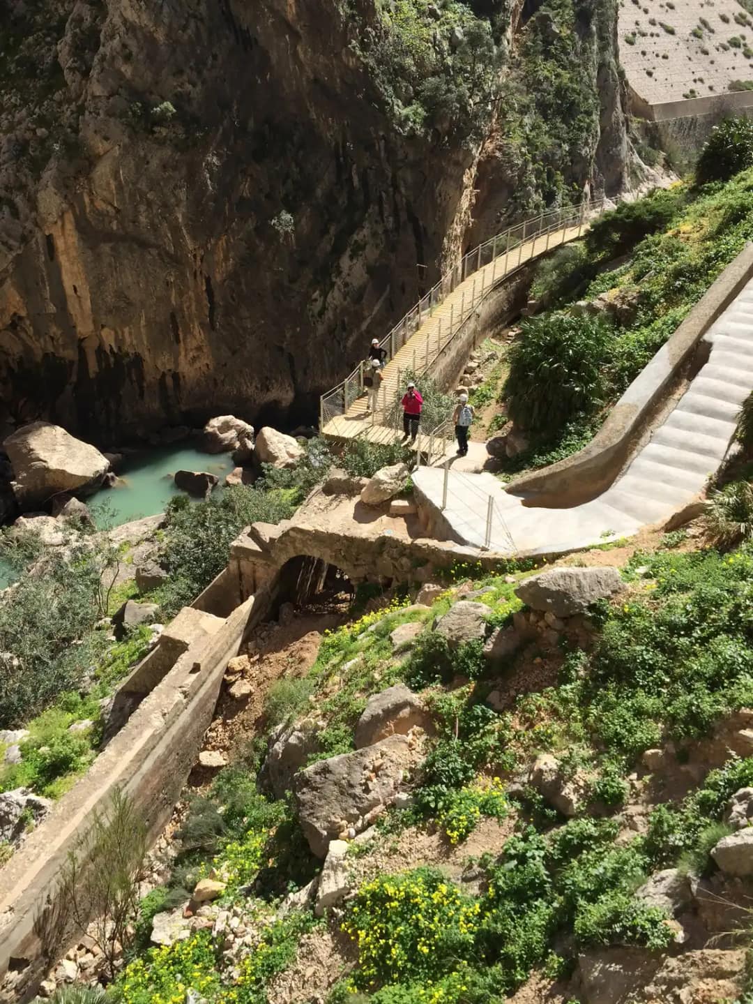 Kładki i schody Caminito del Rey schodzące w dół południowego wąwozu, w dole turkusowa rzeka